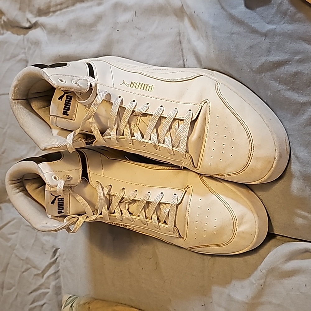 Mens White, Black, and Gold Pumas, size 11.5 U.S.
